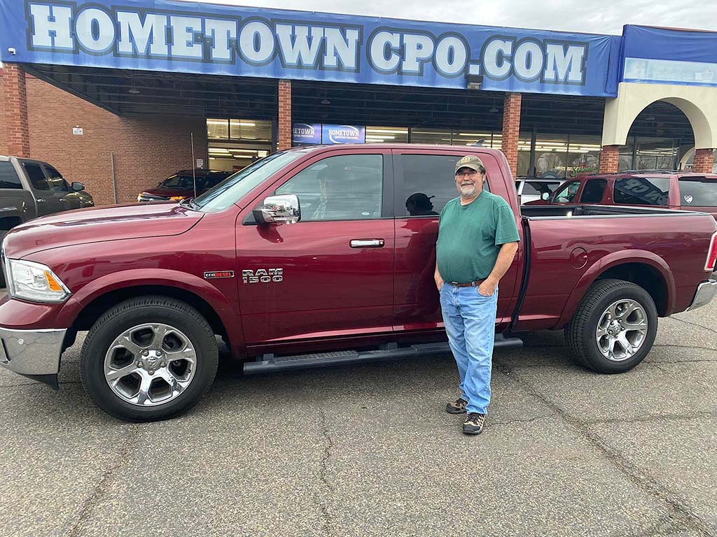 A happy customer with his newly purchased preowned truck in Ironton, OH